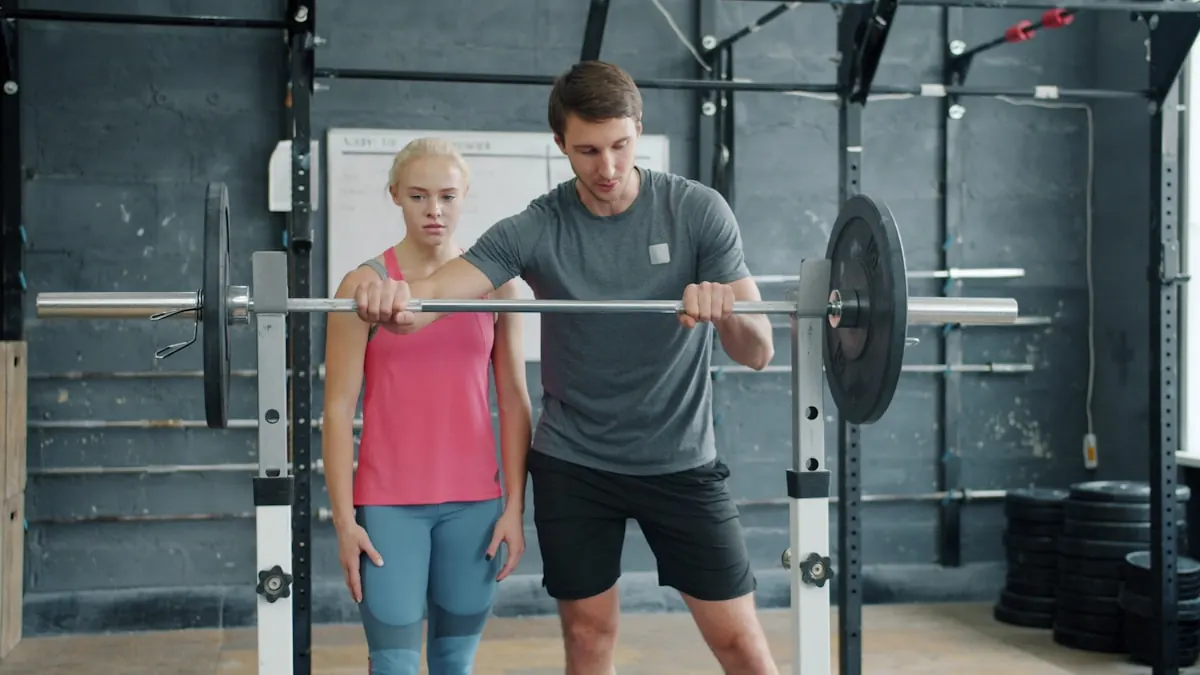 Coach adjusting a member's grip on the bar before a lift