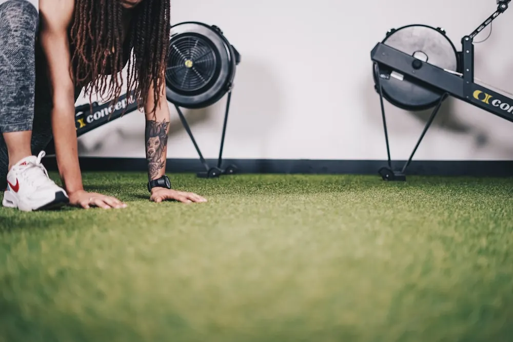 Member doing push ups on the turf during a full body class